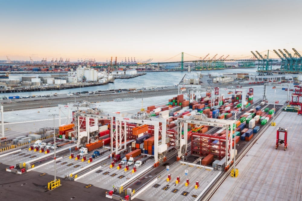 modern container terminal with large cargo ships, automated cranes, and digital operations center, professional photography style